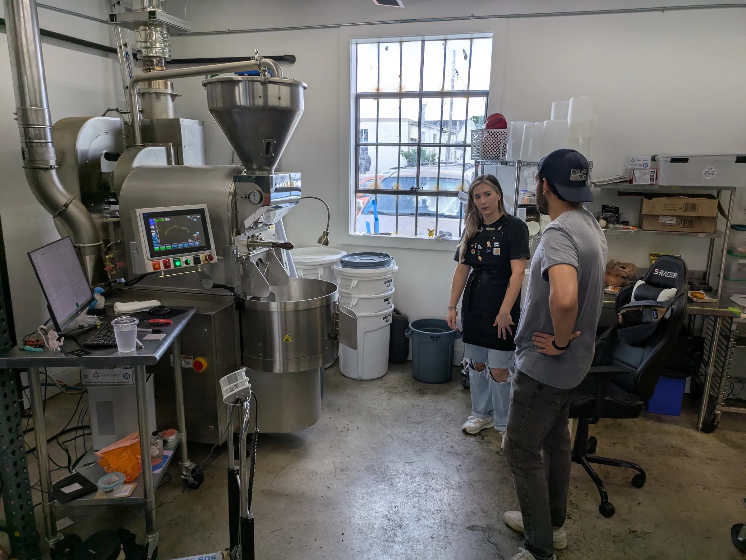 Juan working the coffee roaster at Brass Horn during the founding era of El Gato Negro