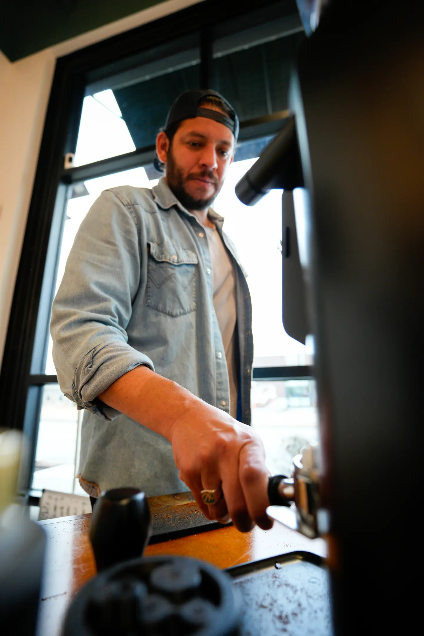 Juan grinding coffee