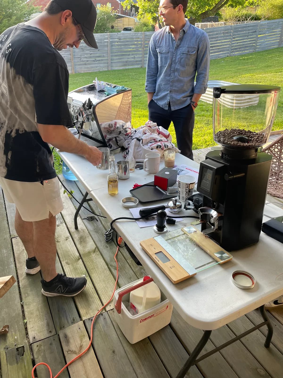 Phil Bartko testing the espresso machine at the first outdoor tasting on a backyard deck
