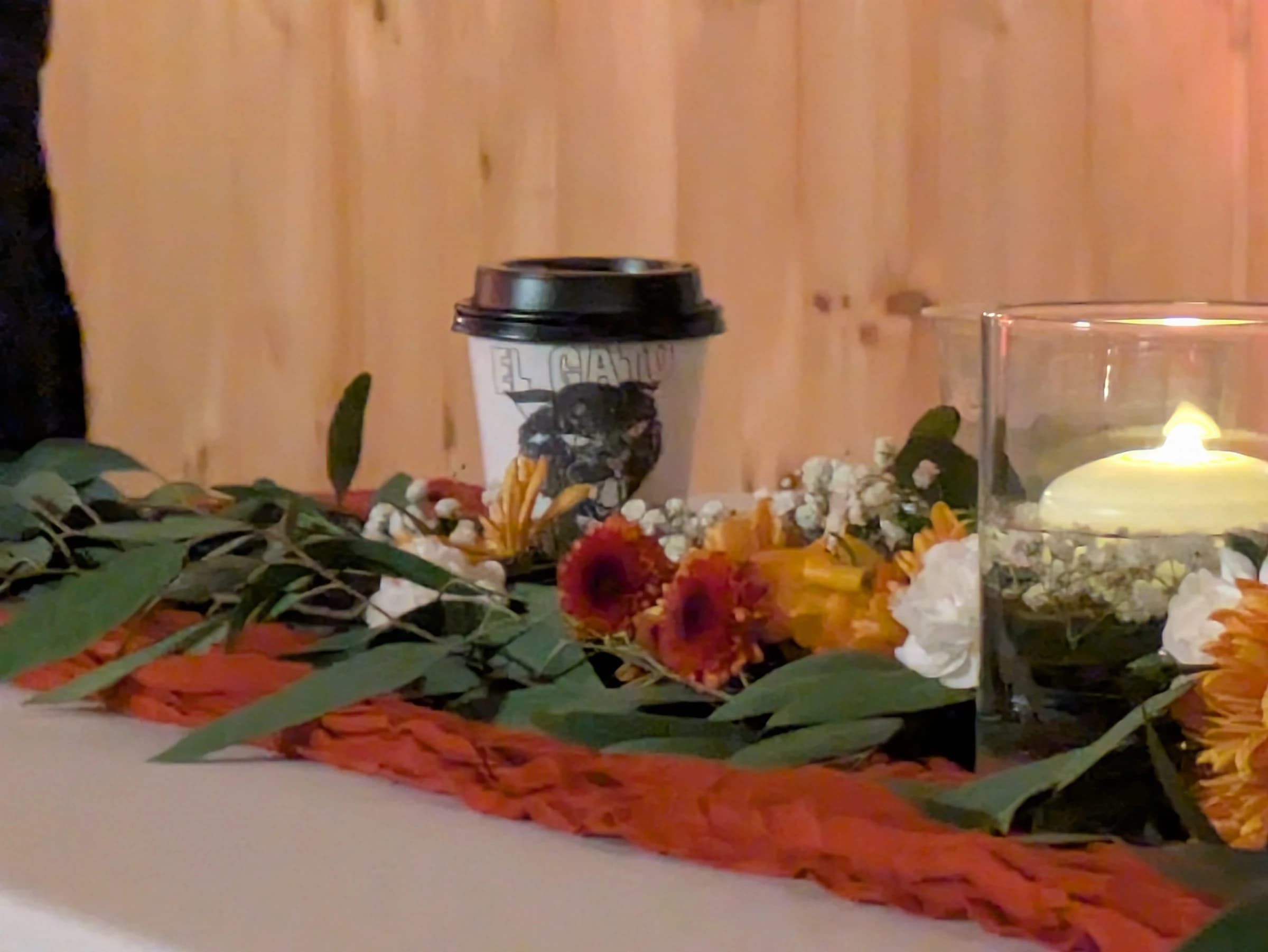 Close-up of an El Gato Negro espresso drink with wedding flowers, styled for a Nashville reception